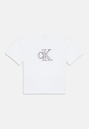 White cotton t-shirt featuring a central embroidered "ck" logo in black and gray, rounded neckline, and short sleeves.