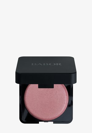 Compact de blush rond avec une poudre rose douce. Couvercle carré noir avec le logo 'BABOR'. Texture lisse, base transparente montrant la teinte du produit.