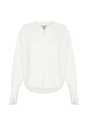 Hvid sweatshirt med V-udskæring, lange ærmer og sideslidser. Har en afslappet pasform med afrundet kant og ribstrikkede manchetter ved ærmerne.