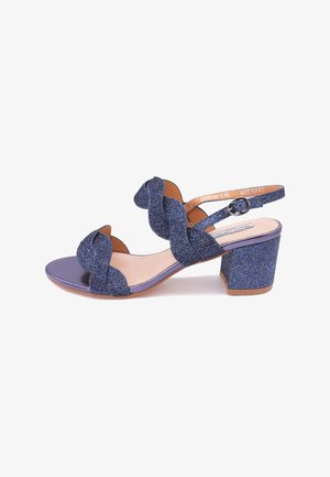 Sandali con tacco lucidi blu glitterati, con fasce ondulate, design open toe e tacco a blocco. L'interno presenta un materiale beige liscio.