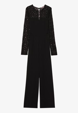 Combinaison noire avec de longues manches en dentelle, décolleté en œil de bœuf et coupe à jambes larges. Fabriquée dans un tissu doux et texturé.