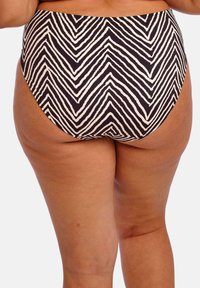 Korkeavyötäröinen bikinin alaosa musta-valkoisena, jossa on chevron-kuvio. Sileä pinta, ommellut reunat ja täydellinen peittävyys.