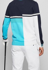 Färgbockad sweatshirt med paneler i marinblått, vitt och turkost, med ribbade ärmslut och en kontrasterande horisontell randdetalj.