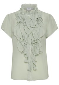 Blouse vert clair en tissu doux avec un devant froncé et un col haut froncé. Les manches courtes et la fermeture à boutons complètent le design.