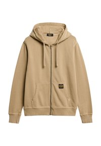 Sudadera con cremallera beige hecha de una tela suave, con un bolsillo frontal, puños acanalados y una etiqueta en el bolsillo izquierdo. Capucha con cordones.