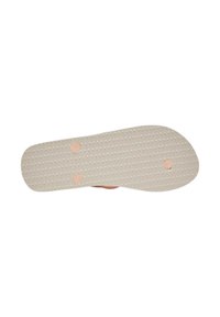 Sole in gomma di color beige chiaro con superficie grip testurizzata. Presenta due dettagli a motivo circolare e una leggera curvatura nella punta.