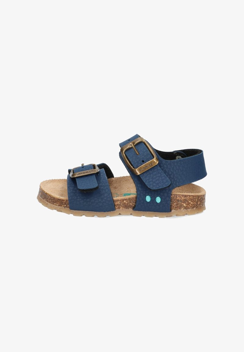 Blaue Sandalen aus strukturiertem Material mit zwei verstellbaren Riemen, einer Schnallenakzent und einem Korkfußbett. Die Sohle hat türkisfarbene Punkte.