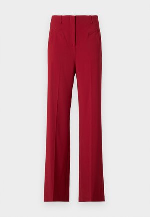 Punased kohandatud püksid sirge lõikega, millel on esiosas taskud ja sile kangas. Ei mingit nähtavat kinnitust ega kaunistusi.