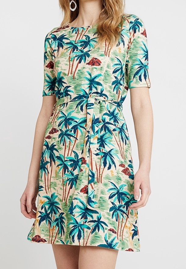 Kratké šaty s krátkým rukávem vyrobené z zelené látky s barevným vzorem palmových stromů. Obsahují detail vázání v pase a rozšířený lem.
