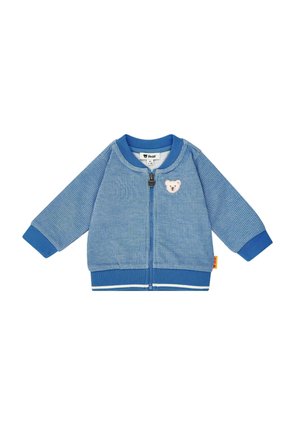 Blaue Cordjacke mit weißem Bärenaufnäher, Reißverschluss und gerippten Bündchen. Verfügt über eine strukturierte Oberfläche und kontrastierende Streifen am Saum.