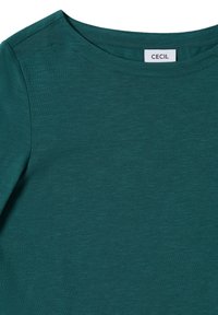 Türkiser Rundhalsausschnitt-T-Shirt aus strukturiertem Stoff. Verfügt über ein Etikett mit der Marke "CECIL". Glatte Oberfläche, lässiges Design und entspannter Schnitt.