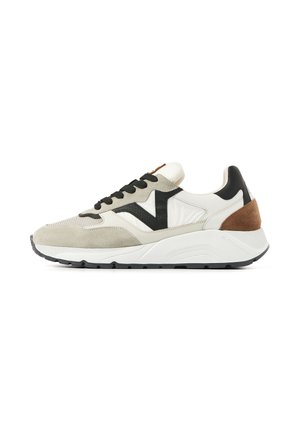 White, beige, and brown sneaker with black accents, black laces, and thick white sole, shown in side profile on a white background.