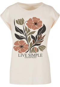 T-shirt crème avec des manches courtes présentant un grand motif floral dans des teintes de rose pâle, vert et noir, et la mention "VIVE SIMPLE ET ÉPANOUIES" imprimée en bas.