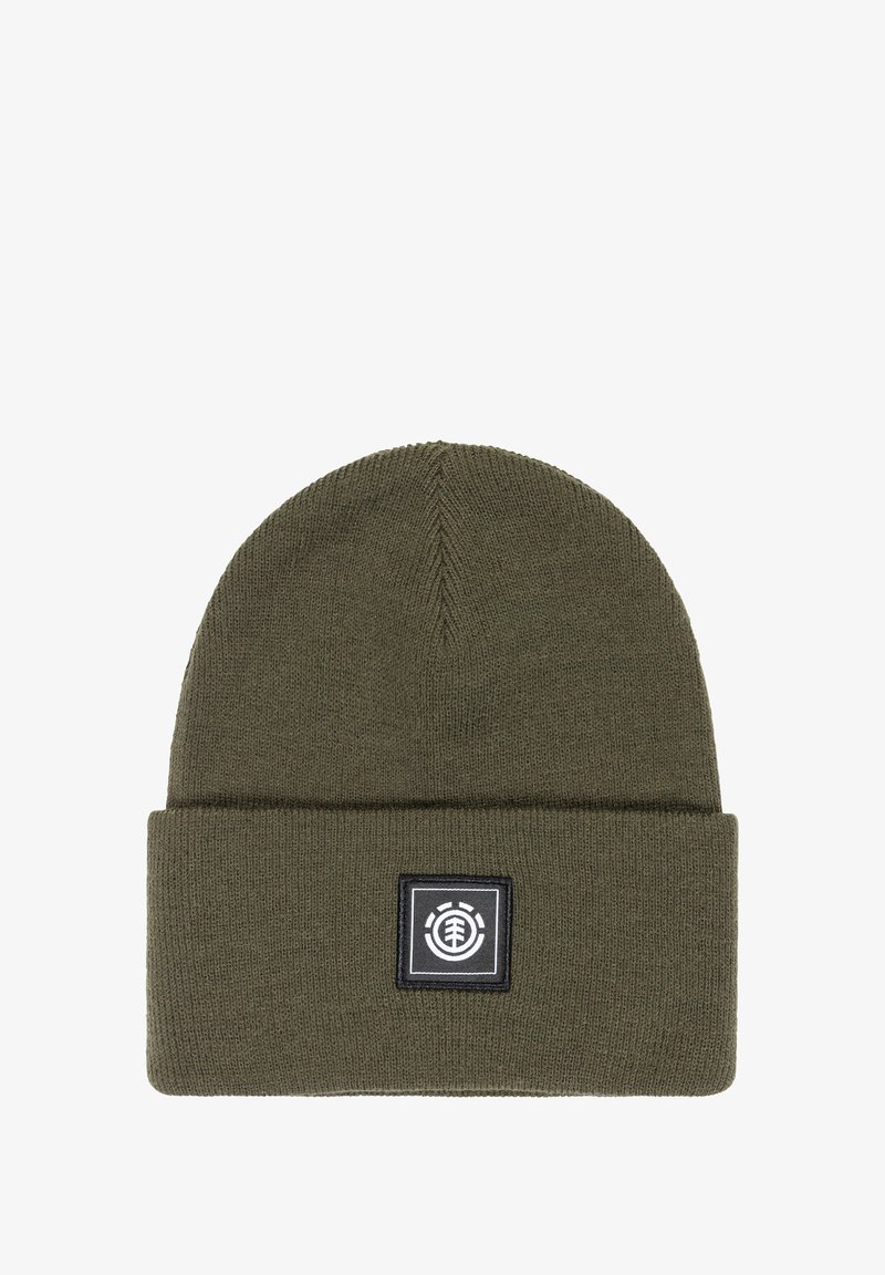 Olive green knit beanie with a folded cuff and a square black label featuring a white logo. Soft texture and close-knit design.