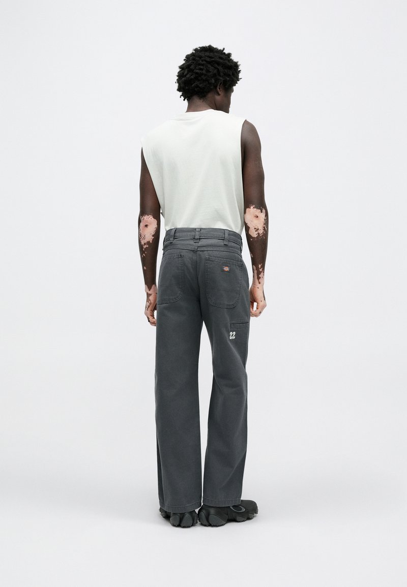 Gray wide-leg pants with back pockets, embroidered logo, and visible stitching details. Cotton blend with a soft texture. Casual fit.