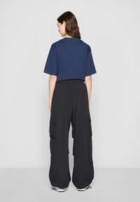 New Balance PANT - Παντελόνι cargo - black