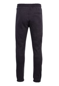 Schwarze Jogginghosen aus Baumwolle mit elastischem Bund, schmal zulaufenden Säumen und einer einzelnen Gesäßtasche. Glatte Textur und minimalistisches Design.