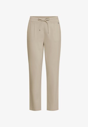 Beżowe dopasowane spodnie z elastycznym paskiem, sznurkiem do wiązania, plisami bocznymi oraz ozdobnym metalowym logo na prawej biodrze.