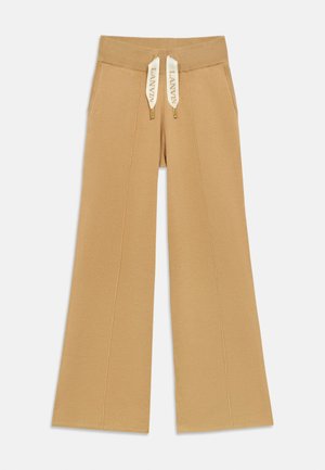 Bežové široké tepláky s rebrovaným pásom a šnúrkou s brandingom "LANVIN". Hladká tkanina a detailovanie predného švu.