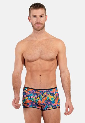 Colorful men's swim trunks with a floral pattern in shades of blue, orange, and green. Made of smooth, stretchy material with a fitted design.
