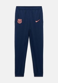 Marine sportbroeken met het FC Barcelona-embleem en een roze Nike-logo. Gemaakt van gladde stof met elastische boorden en tailleband.