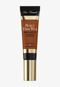 Brown tube of foundation with gold and black accents. Features include a matte finish, oil control, and highlighted text for product details.