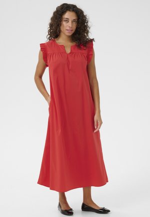 Rotes, knielanges Kleid mit ausgestelltem Schnitt, Rüschenschultern und einem Schlüsselloch-Ausschnitt. Aus glattem Stoff gefertigt, mit seitlichen Taschen.