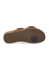 Brown sandals with a textured rubber sole, adjustable straps, and a soft suede accent, featuring a wavy tread pattern for grip.
