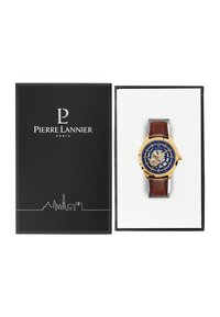 Gold and navy watch with a brown leather strap, featuring a detailed dial, displayed in a black box with white interior and logo.