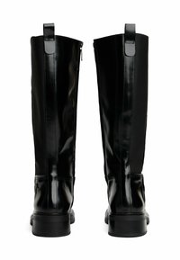 Pair of tall black leather boots with chunky heels and back pull tabs, shown from the rear on a white background.