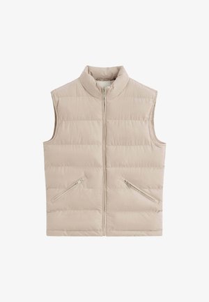 Veste matelassée beige sans manches avec col montant, fermeture zippée à l'avant et deux poches zippées en diagonale.