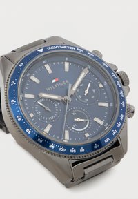 Orologio cronografo da uomo con quadrante blu navy, dettagli color argento, ghiera tachimetrica e cinturino in acciaio inox. Dotato di tre quadranti secondari.