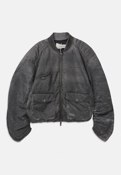 Gray bomber jacket made of textured fabric, featuring a front zip, large pockets, and an elasticized waistband and cuffs.