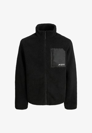 Melnas vilnas jaka ar augstu apkakli, ar rāvējslēdzēja krūšu kabatu un teksturētu audumu. Priekšējais rāvējslēdzējs, vienkāršs dizains.