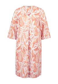 Leichtes, V-Ausschnitt-Kleid in sanftem Pfirsich mit weißem Blattmuster. Mit kurzen Ärmeln und lockerer, lässiger Passform. Glatte Stofftextur.