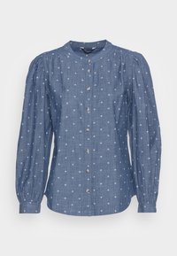 Modrá košile na knofl�íky s dlouhými nadýchanými rukávy, vyrobená z texturované látky, s bílým křížovým vzorem a stříbrnými knoflíky na přední straně.