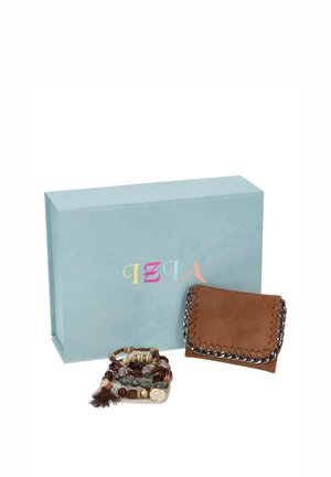 Una cartera de cuero marrón con detalles de cadena y unas pulseras de cuentas están delante de una caja de regalo azul claro.