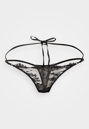 Schwarzer Spitzen-String mit durchsichtigem Netzstoff, Blumenmustern, dünnen Trägern und einer Bindung am Rücken. Mit weicher Textur und minimaler Bedeckung.