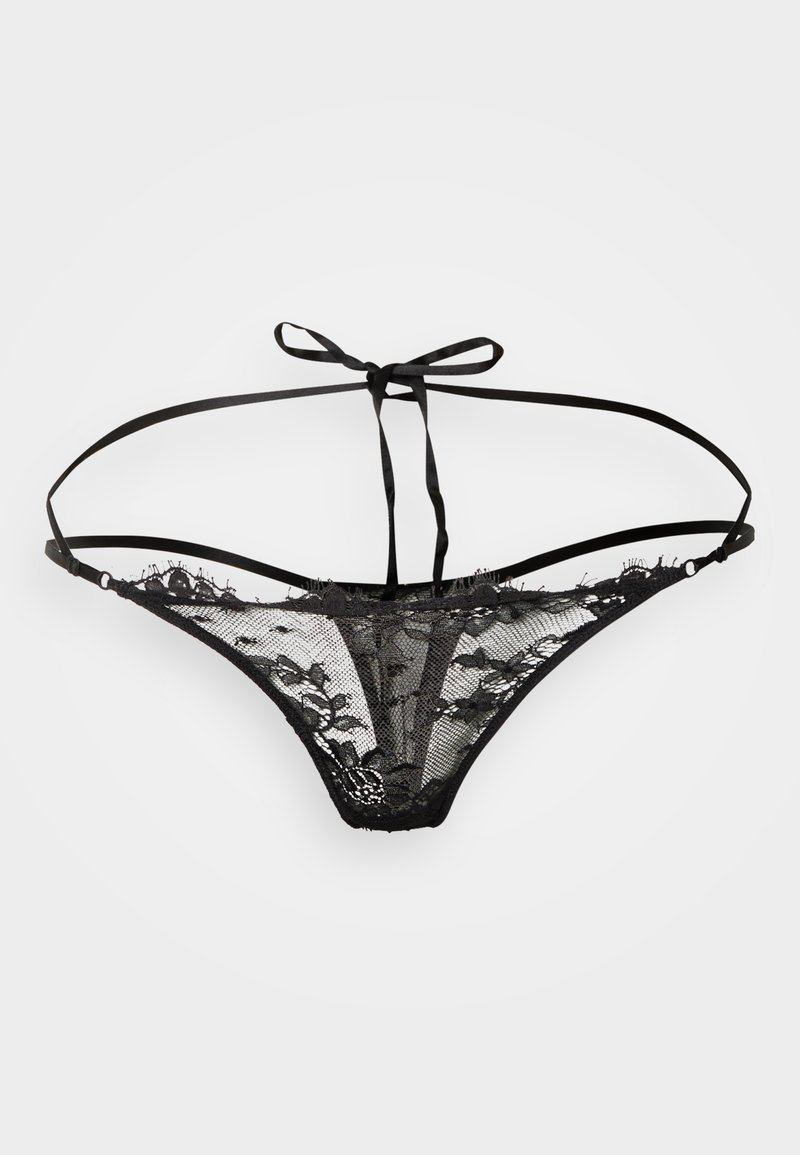 Melns mežģīņu tangas biksītes ar caurspīdīgu tīkls audumu, ziedu rakstiem, plānām lencītēm un aizmugurējo saišu detaļu. Raksturo mīkstu tekstūru un minimālu pārklājumu.