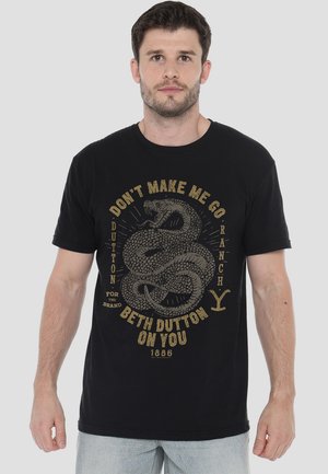 Black short-sleeve t-shirt featuring a gold snake graphic and text, made from cotton fabric with a relaxed fit.