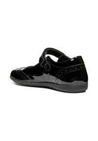 Black patent leather shoe with a Mary Jane strap, featuring perforated accents and a smooth textured sole. Curved design and closed-back style.