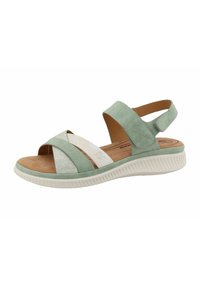 Green suede sandal with crisscross design, elastic straps, white accent strip, cushioned insole, and textured white rubber sole.