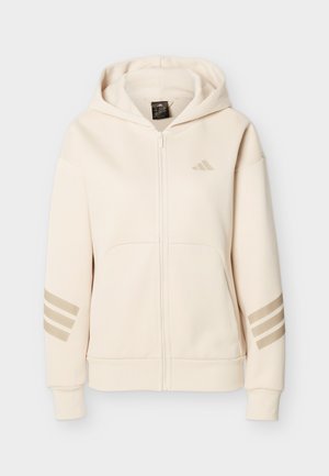 Lysebeige hættejakke med lynlås, lavet af blødt stof, med hætte, to forlommer og tre grå striber på hver ærme.