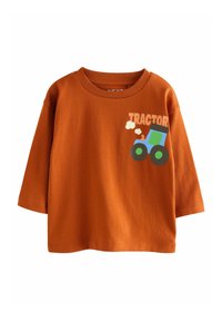 T-shirt in cotone arancione con colletto rotondo e maniche corte. Presenta un grafico di un trattore in blu e verde con la parola "TRACTOR" in grassetto.