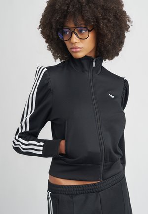 Schwarze Reißverschlussjacke mit weißen drei Streifen an den Ärmeln. Verfügt über einen hohen Kragen und Seitentaschen, gefertigt aus glattem Stoff.