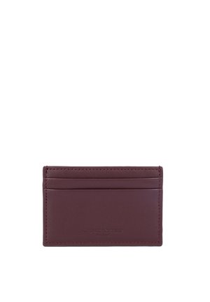 Burgundy leather card holder with four card slots, minimalist design, embossed logo on the front, smooth texture, and clean edges.