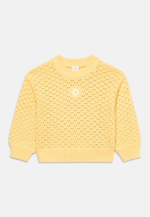 Kollane kootud kampsun soonikkoega krae, mansettide ja alumise äärega ning keskel esiküljel tikitud väike valge karikakar.