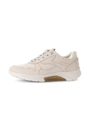 Beige athletic shoe with smooth leather upper, padded collar, and textured sole. Features reflective laces and a contrasting rubber heel accent.