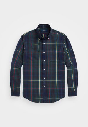 Camicia a quadri a maniche lunghe con bottoni, blu scuro con linee rosse, gialle e verdi, con tasca frontale e colletto con bottoni.