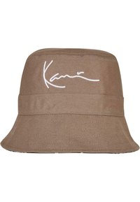 Brown bucket hat made of textured fabric, featuring a white embroidered signature. Wide brim and structured base, casual design.